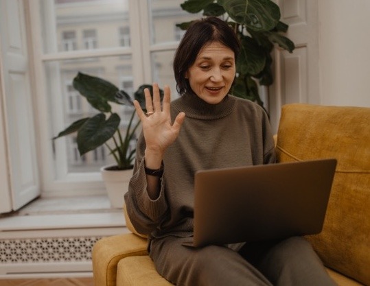 cheerful-adult-fairskinned-woman-communicates-via-video-link-with-relatives-quarantine-waving-her-hand-while-sitting-sofa-living-room-enjoying-little-things-positive-attitud en tamaño mediano cheerful-adult-fairskinned-woman-communicates-via-video-link-with-relatives-quarantine-waving-her-hand-while-sitting-sofa-living-room-enjoying-little-things-positive-attitud en tamaño mediano